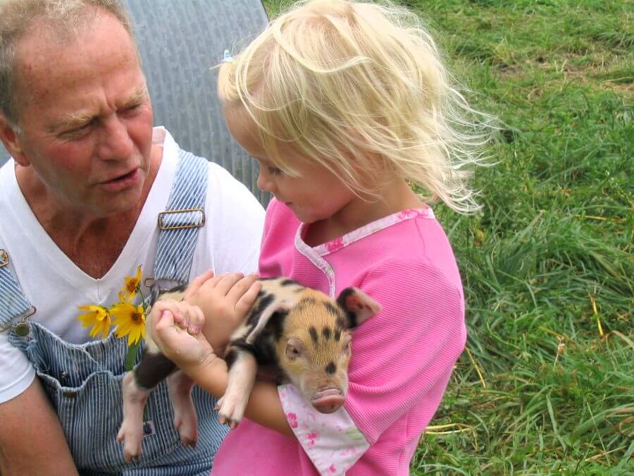 Sarah's daugher, Sophia, at a young age with Sarah's father, Paul Willis, on the family farm. 